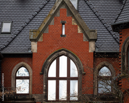 Red brick building facade with arched windows