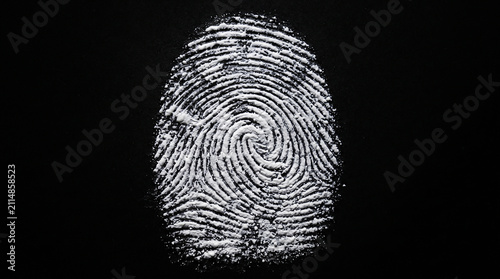 Glowing blue futuristic digital fingerprint scanning on high tech cyber security interface