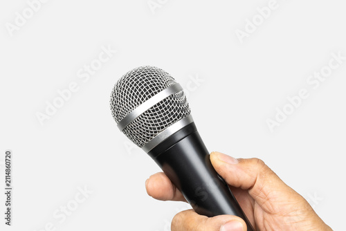 Картината върху платно Male hand with microphone isolated on gray background.