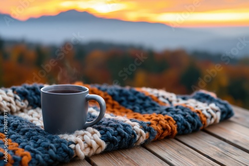 Coffee in a warm mug on a cozy knitted wool blanket during a beautiful autumn day