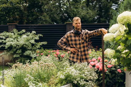 Man enjoying gardening working in beautiful backyard
