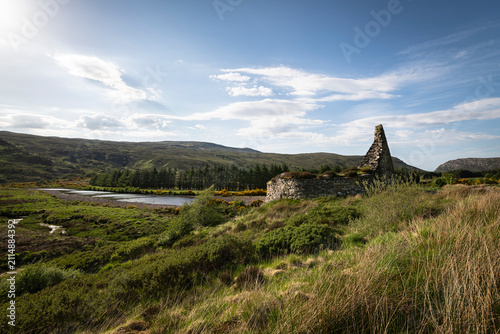 A bright summer, wide angled HDR landscape image of the remains of the Iron Age Broch, Dun Dornaigil in Strath more, Sutherland, Scotland