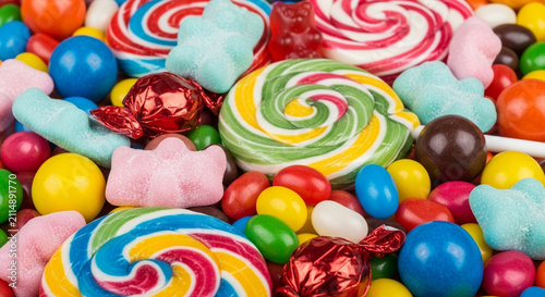 Various colorful candies with different flavors on a white background.
