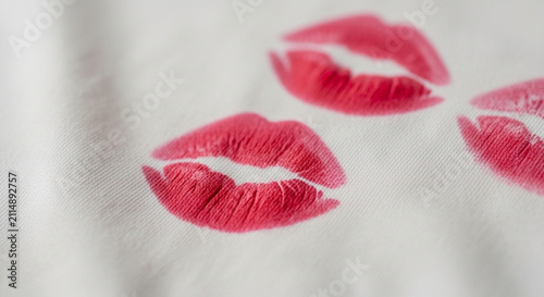 Aesthetic red lipstick kiss trail on a piece of white cloth.