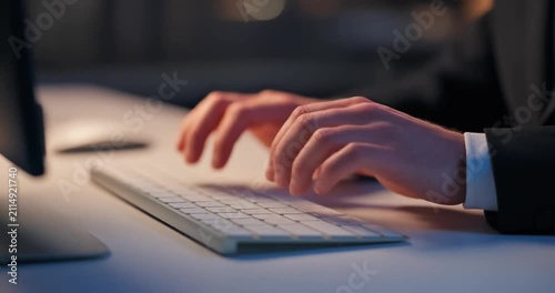 Close up of hands typing on computer keyboard