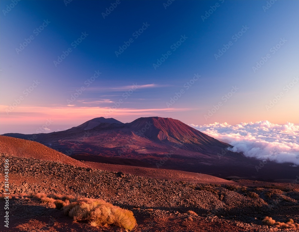 Naklejka premium distant mauna kea summit disappears into soft pink clouds sky volcano peaceful
