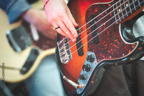 Close-up of Hand Playing Electric Bass Guitar Strings