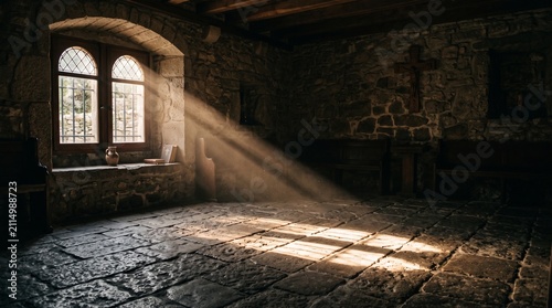Sunlight streaming through a window onto a textured stone floor, casting dramatic light beams and shadows inside a dark room to create a peaceful and spiritual atmosphere