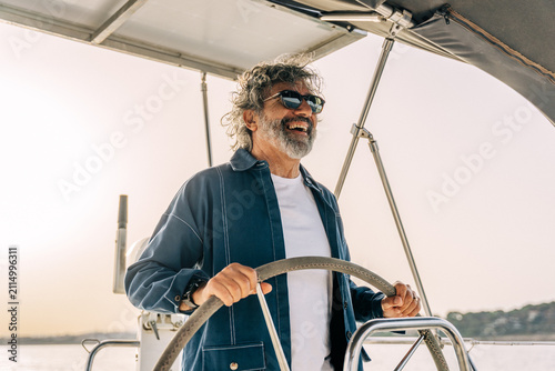 Canvastavla Smiling man steering sailboat enjoying freedom and adventure