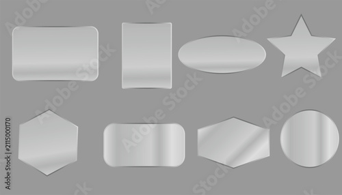 A collection of silver metallic blank labels and frames with various geometric shapes isolated on a solid grey background for design