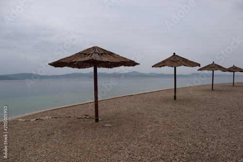 Beach with beach umbrellas on a rainy day