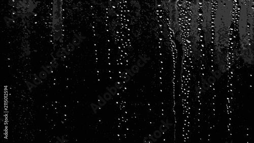 Konstfotografi Water droplets on glass create a textured monochrome pattern with varying sizes