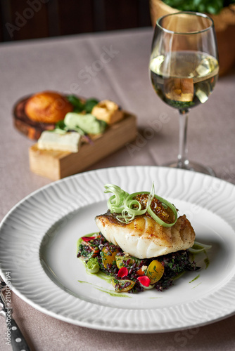Fotografie Pan seared fish fillet with white wine and gourmet side dish