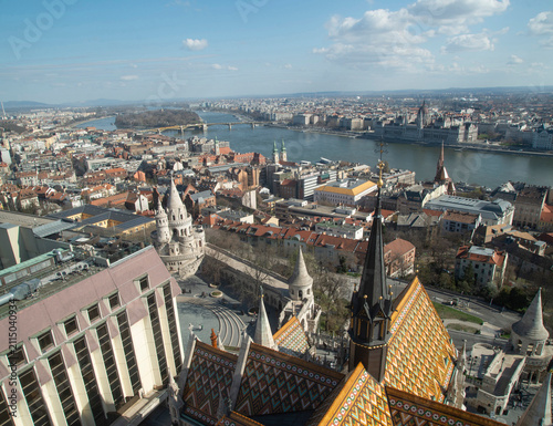 Zsolnay glazed roof tiles of Matthias Church with Budapest skyline view from Matthias Church tower in Budapest, Hungary