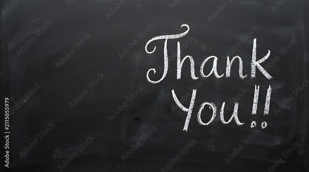 Fototapeta premium Thank you written in white chalk on a black chalkboard background