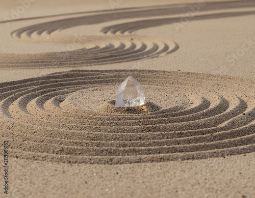 minimalist landscape featuring a transparent quartz crystal rising naturally from untouched desert sand illuminated by warm sunrise light