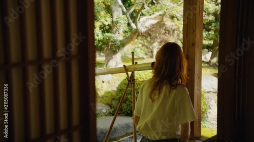 Woman contemplating a traditional japanese garden