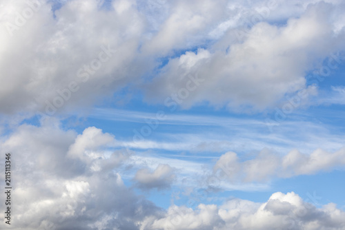 Majestic soft white windy clouds against bright blue sky backdrop, natural landscape
