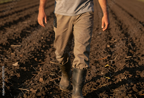 Farmer walking through a fr...