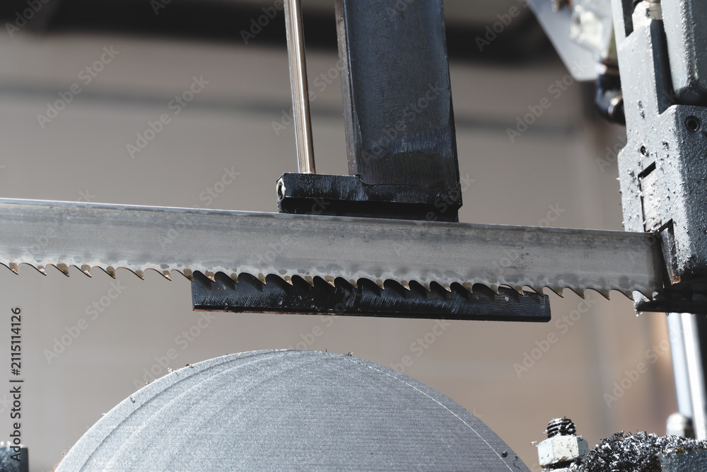 Naklejka premium Thin, round metal discs cut with abandsaw, with metal shavings and lubricant on them. tech industrial technology background