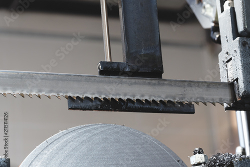 Thin, round metal discs cut with abandsaw, with metal shavings and lubricant on them. tech industrial technology background