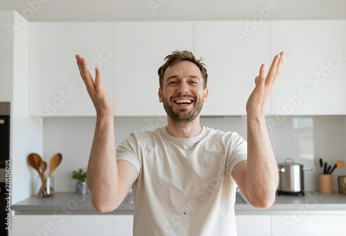 Happy man with arms raised ...