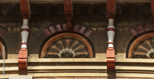 Photography Decorative tiles and patterned brickwork form a detailed Dunkirk façade, where color and craft stand out in the sunlight