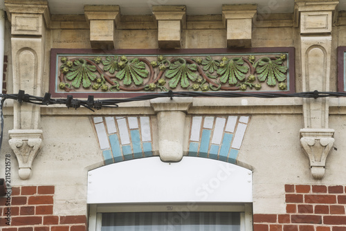 Photography Decorative tiles and patterned brickwork form a detailed Dunkirk façade, where color and craft stand out in the sunlight