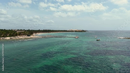 Aerial view of Caribbean sea ,sandy beach, pier with docked boats and palm trees in Playa del Carmen, Cancun, Mexico