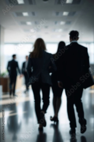 Blurred motion of business people walking through modern office