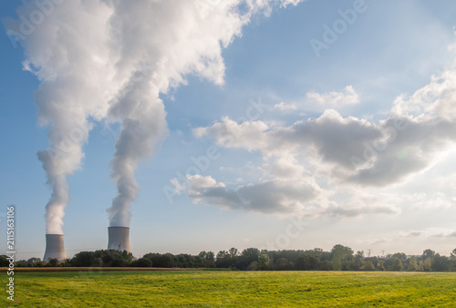 Cooling Towers and Steam Clouds Over Open Countryside