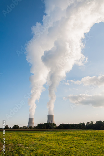 Industrial Cooling Towers Rising Above Rural Landscape
