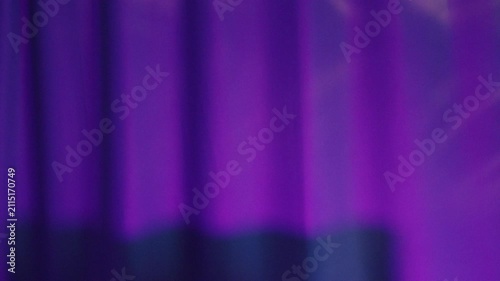 Stage backdrop with vivid colors. Dramatic velvet drapery enhances theatrical atmosphere. Cinematic scene featuring deep hues and textured fabric effects