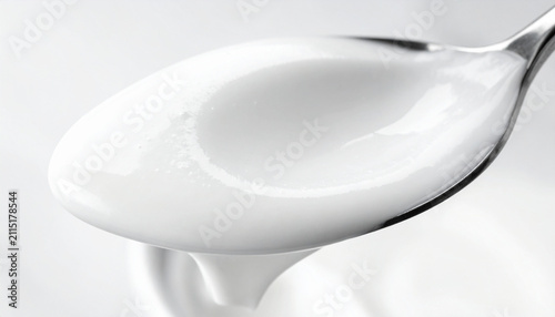 Macro yogurt spoon scoop with deep indentation and creamy texture detail
