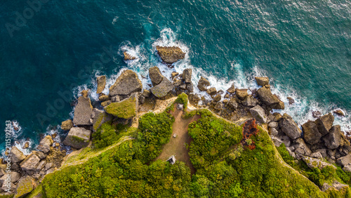 Aerial view of Cabo Frances Viejo, featuring lush green cliffs, dense vegetation, and turquoise waters meeting the Atlantic Ocean in Cabrera, Maria Trinidad Sanchez, Dominican Republic.