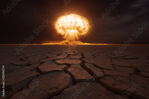 Dramatic nuclear mushroom cloud explosion over a dry cracked desert soil landscape at night