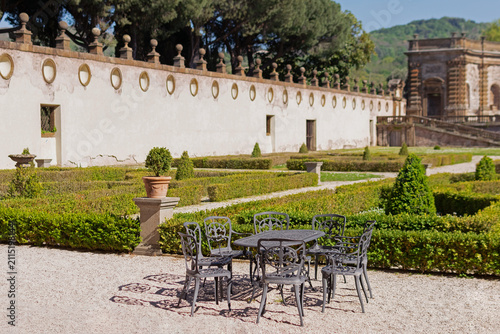 Принти на полотні Renaissance garden at Villa Mondragone with black wrought iron chairs, an oval m