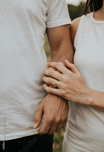 Engaged couple holding hand...