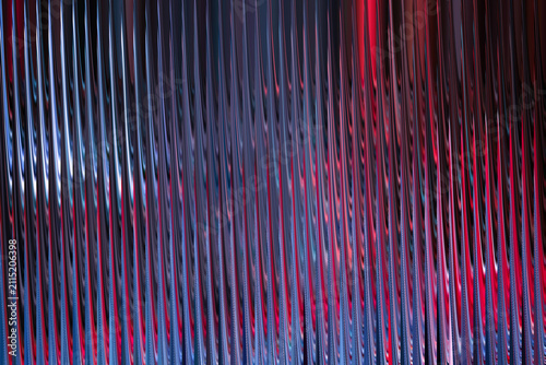 Abstract background with vertical wavy lines in blue and red gradient colors, creating a dynamic and modern visual effect