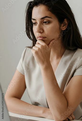 Thoughtful young woman with...