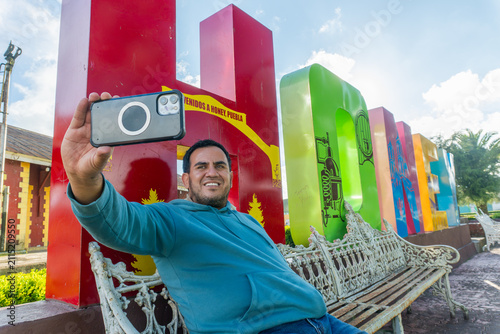 Man taking selfie in honey puebla, mexico