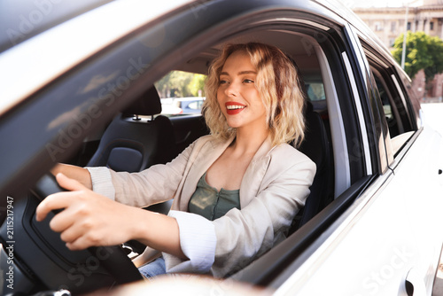 Woman driving modern car  view from outside