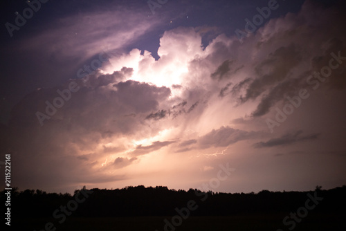 Heavy clouds bringing thunder, lightnings and storm. Thunderstorm flashes with multiple bolts of lightning.
