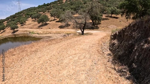 Via de la Plata - a gravel road close to a small lake halfway between Almaden de la Plata and Real de la Jara, province of Seville, Andalusia, Spain