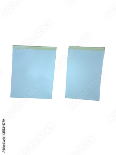Two light blue sticky notes on a flat surface