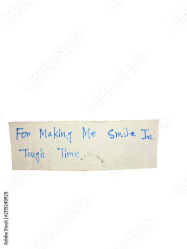 Handwritten note on paper strip with blue ink text