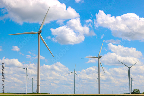 Wind turbine farm producing renewable energy in rural landscape