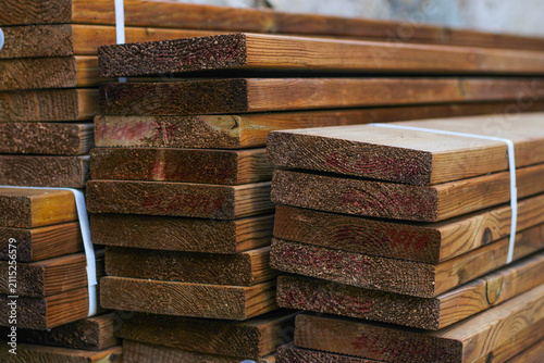 Stack of brown wooden planks, floor construction planks