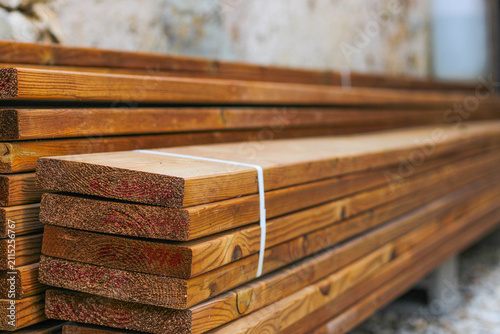 Stack of brown wooden planks, floor construction planks