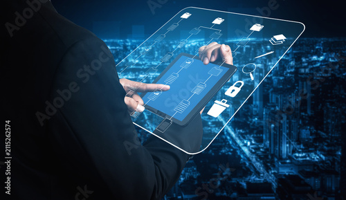 Foto Business Professional Using Digital Tablet to Access Data Visualization with Futuristic Interface Overlooking Cityscape at Night